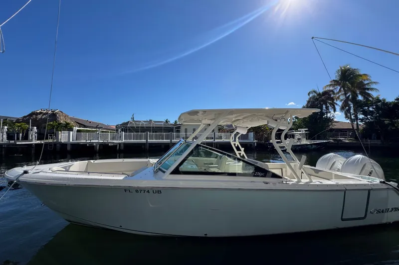 The Image of 2025 Sailfish 276 DC boat docked under clear blue sky. - 0