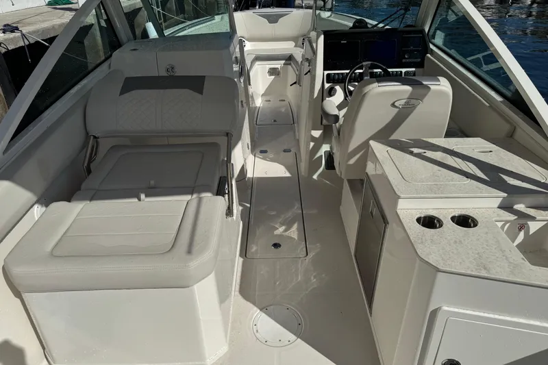 Slide: The Image of 2025 Sailfish 276 DC boat interior with seating, helm, and console. - 13