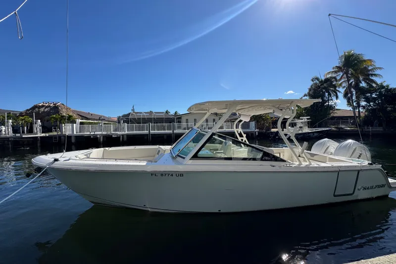 Slide: The Image of 2025 Sailfish 276 DC boat docked on a sunny day, showcasing sleek design and modern features. - 16