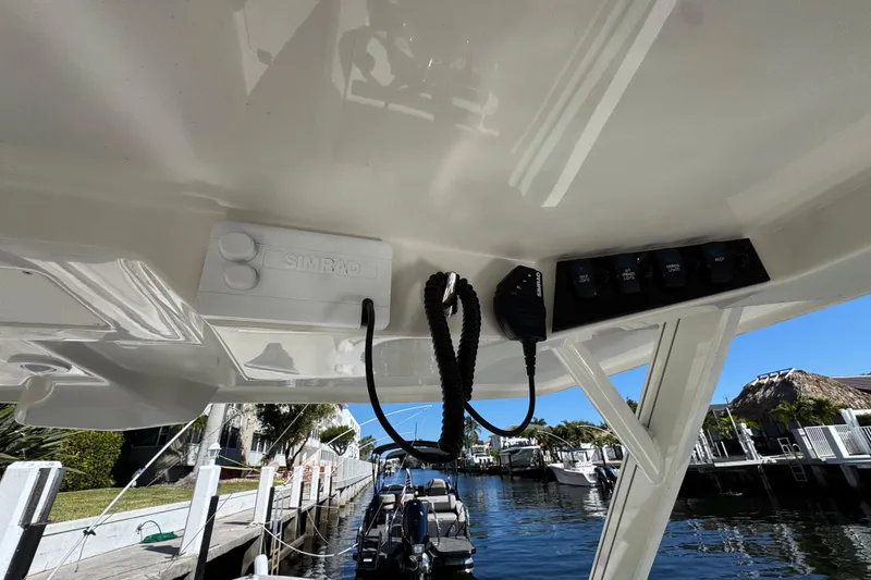 Slide: The Image of 2025 Sailfish 276 DC boat dashboard with Simrad electronics and control panel. - 18