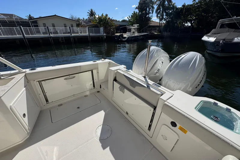 Slide: The Image of 2025 Sailfish 276 DC boat with Yamaha engines docked by waterfront homes. - 24