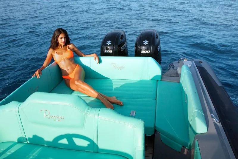 Slide: The Image of Woman relaxing on a 2026 Ranieri CAYMAN 27.0 SPORT TOURING boat in turquoise seating. - 11