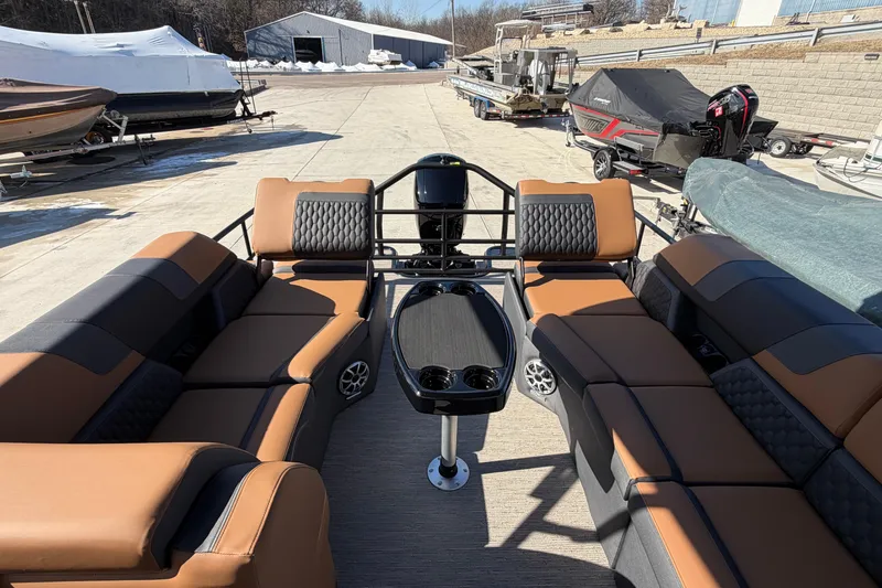 Slide: The Image of 2025 Sylvan L-3 SLZ pontoon boat interior with luxurious seating and central table. - 7