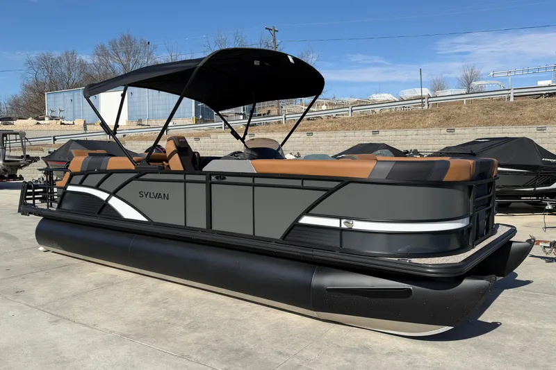 The Image of 2025 Sylvan L-3 SLZ pontoon boat with sleek design and canopy, parked outdoors. - 1