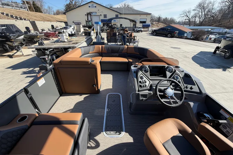 Slide: The Image of 2025 Sylvan L-3 SLZ pontoon boat interior with modern dashboard and seating. - 11