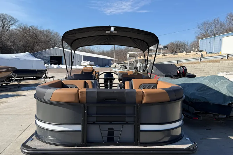 Slide: The Image of 2025 Sylvan L-3 SLZ pontoon boat with canopy, parked outdoors on a sunny day. - 12