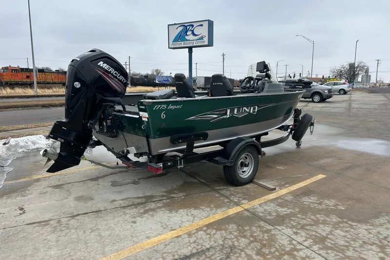 Slide: The Image of 2015 Lund 1775 Impact boat with Mercury engine on trailer in parking lot. - 10