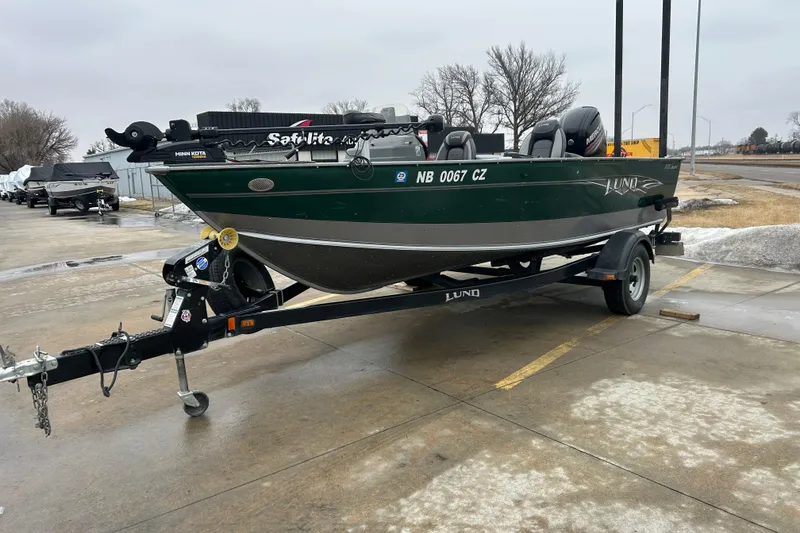 Slide: The Image of 2015 Lund 1775 Impact fishing boat on trailer in parking lot. - 11