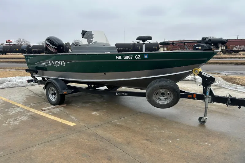Slide: The Image of 2015 Lund 1775 Impact fishing boat on trailer, parked outdoors. - 12