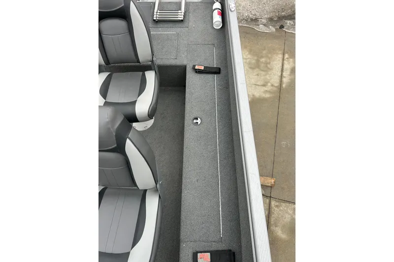 Slide: The Image of 2015 Lund 1775 Impact boat interior with gray seating and storage compartments. - 19