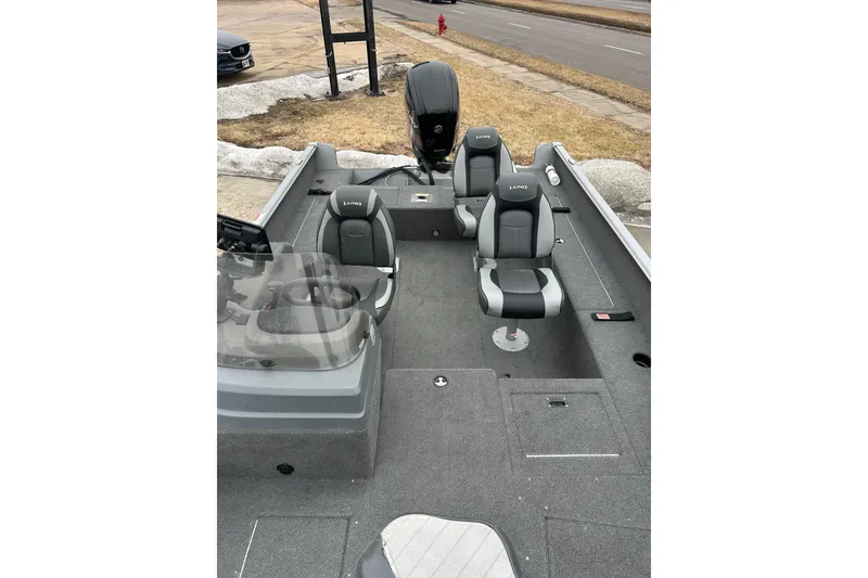 Slide: The Image of 2015 Lund 1775 Impact boat interior with gray seating and steering console. - 22