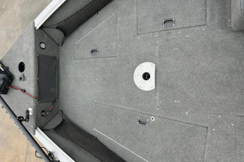 Slide: The Image of 2015 Lund 1775 Impact boat interior with carpeted deck and storage compartments. - 27