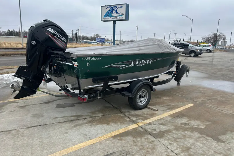 Slide: The Image of 2015 Lund 1775 Impact boat with Mercury engine on trailer in parking lot. - 6