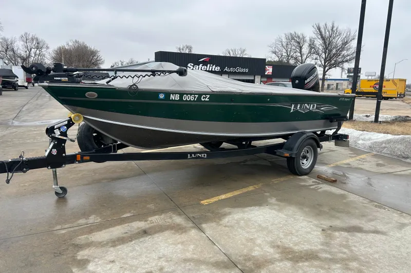 Slide: The Image of 2015 Lund 1775 Impact boat on trailer in parking lot, overcast day. - 7