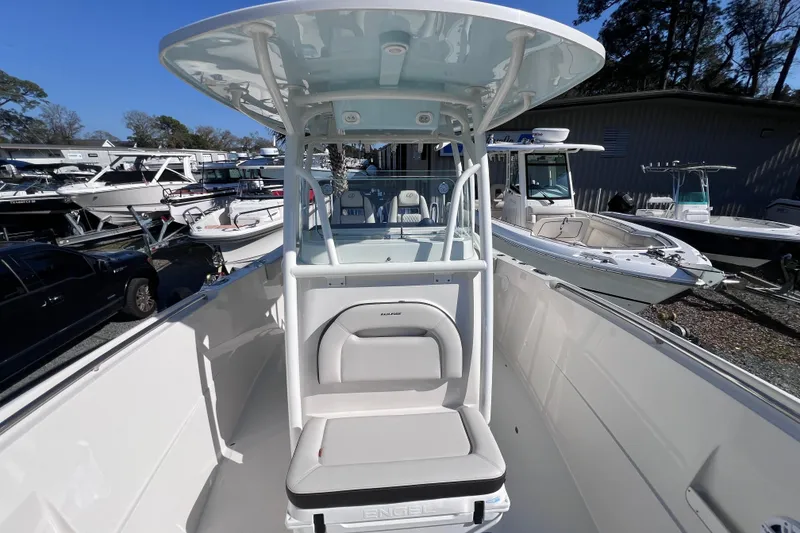 Slide: The Image of 2024 Sailfish 290 CC boat with center console and seating, displayed outdoors. - 14