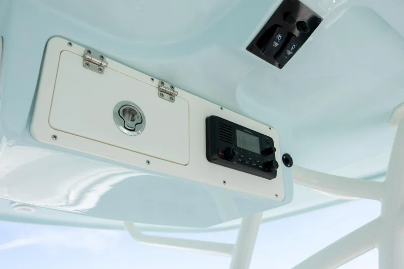 Slide: The Image of 2024 Sailfish 290 CC boat console with radio and storage compartment. - 22
