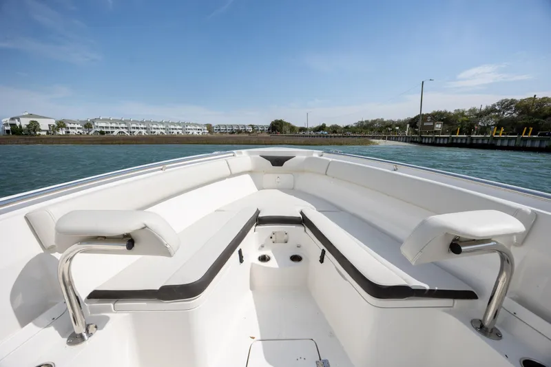 Slide: The Image of 2024 Sailfish 290 CC boat interior with spacious seating and scenic waterfront view. - 25
