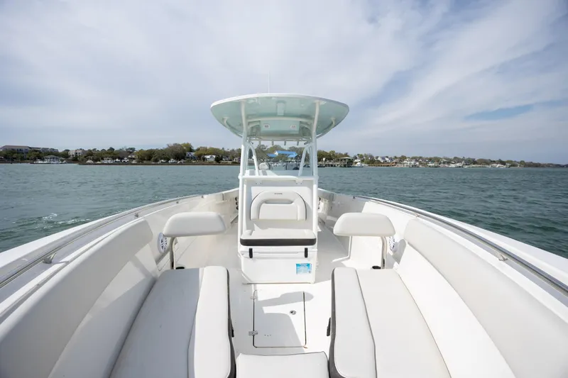 Slide: The Image of 2024 Sailfish 290 CC boat on water, showcasing spacious seating and sleek design. - 26