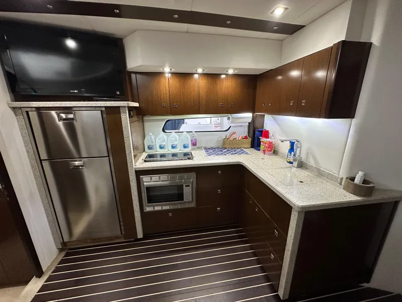 Slide: The Image of 2012 Cruisers Yachts 48 Cantius kitchen with modern appliances and sleek cabinetry. - 11