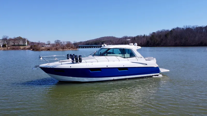 Slide: The Image of 2012 Cruisers Yachts 48 Cantius on a serene lake with clear blue skies. - 7