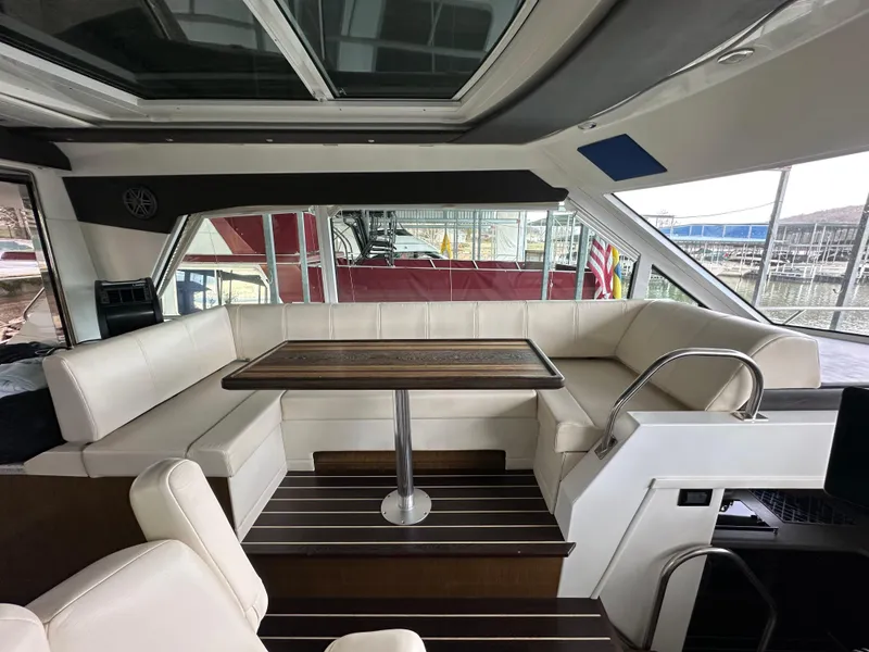 Slide: The Image of Interior of 2012 Cruisers Yachts 48 Cantius with elegant seating and wooden table. - 9