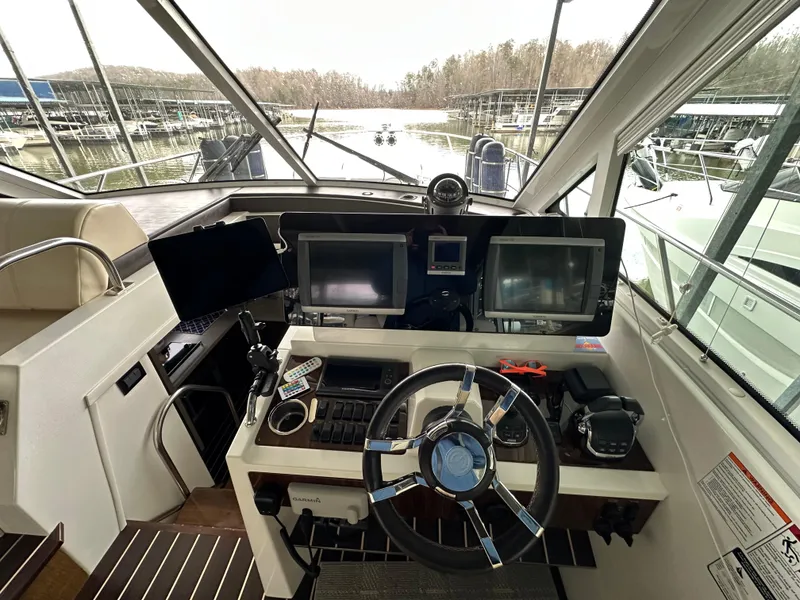 Slide: The Image of 2012 Cruisers Yachts 48 Cantius helm with dual screens and modern controls. - 17