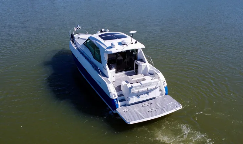 Slide: The Image of 2012 Cruisers Yachts 48 Cantius on calm water, rear view. - 8