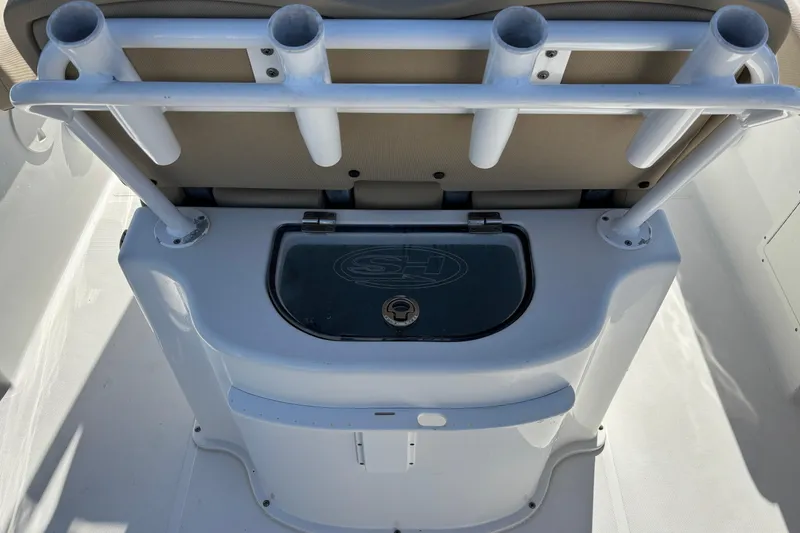 Slide: The Image of 2016 Sea Hunt Gamefish 27 boat interior with rod holders and storage compartment. - 10