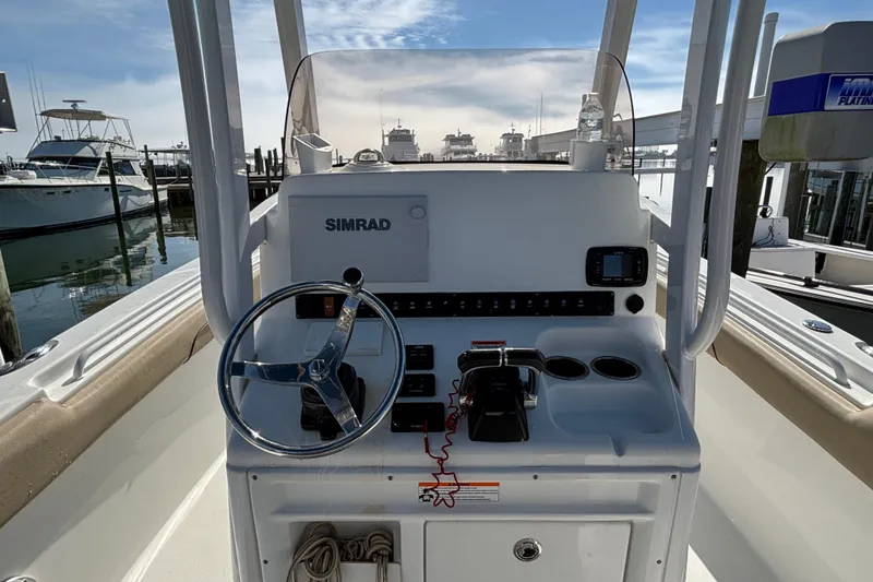 Slide: The Image of 2016 Sea Hunt Gamefish 27 boat console with steering wheel and Simrad electronics. - 12