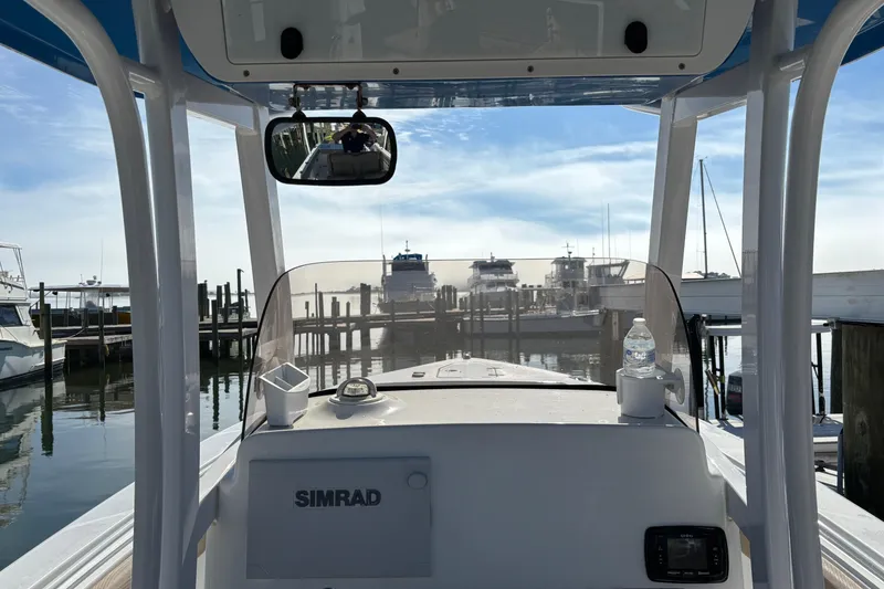 Slide: The Image of 2016 Sea Hunt Gamefish 27 boat at marina, featuring Simrad navigation system. - 13