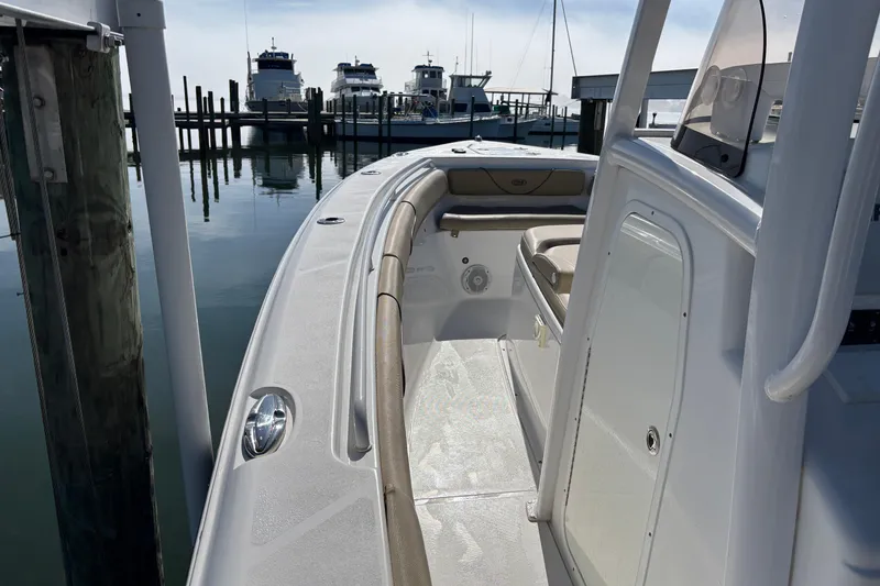 Slide: The Image of 2016 Sea Hunt Gamefish 27 boat docked at marina, showcasing interior and seating. - 18