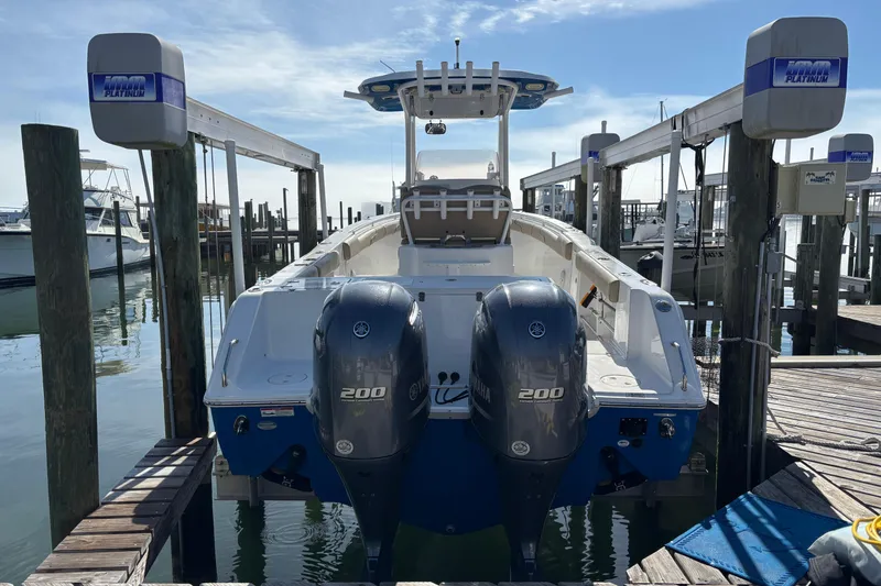 Slide: The Image of 2016 Sea Hunt Gamefish 27 boat docked with dual Yamaha 200 engines. - 2
