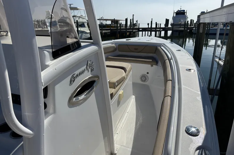 Slide: The Image of 2016 Sea Hunt Gamefish 27 boat docked at marina, showcasing interior seating and design. - 20