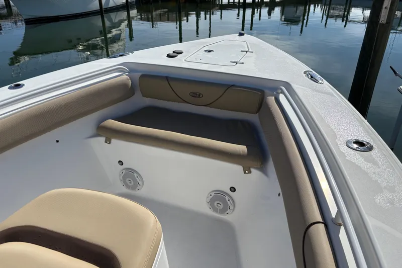 Slide: The Image of 2016 Sea Hunt Gamefish 27 boat interior with cushioned seating and storage compartments. - 21