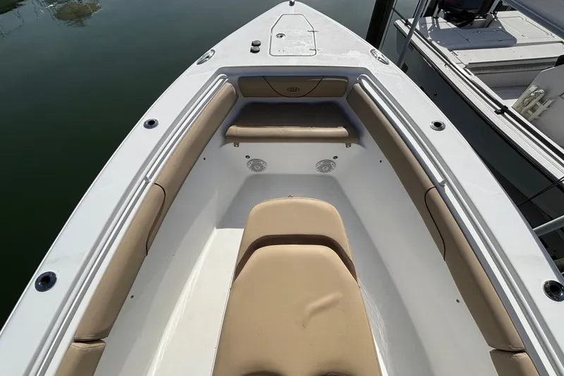 Slide: The Image of 2016 Sea Hunt Gamefish 27 boat interior with beige seating and white deck. - 22