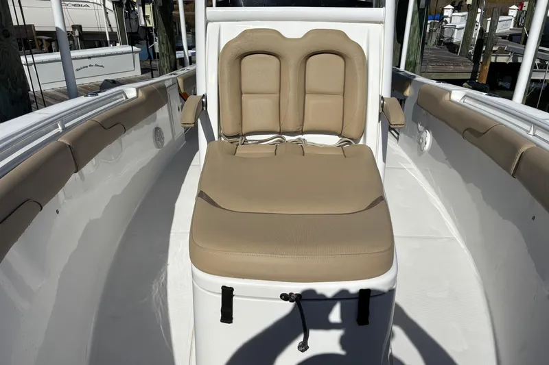 Slide: The Image of 2016 Sea Hunt Gamefish 27 boat interior with tan seating and white deck. - 26
