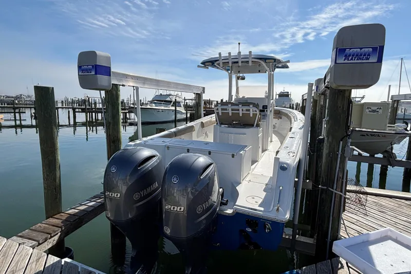 Slide: The Image of 2016 Sea Hunt Gamefish 27 with twin Yamaha engines docked at a marina. - 3
