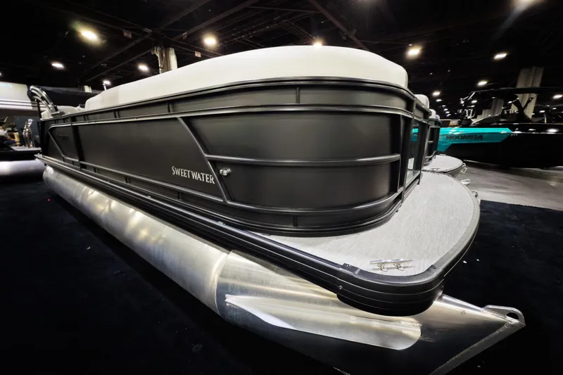 Slide: The Image of 2026 Godfrey Sweetwater 22' Split Bench Tritoon, model 2286 SBC, showcased indoors. - 1