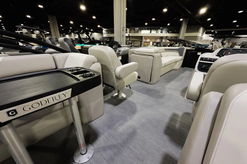 Slide: The Image of Luxurious interior of 2026 Godfrey Sweetwater 22' Split Bench Tritoon, showcasing plush seating. - 12