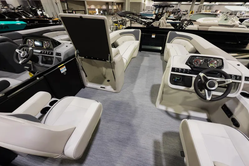 Slide: The Image of Interior of 2026 Godfrey Sweetwater 22' Split Bench Tritoon, featuring modern helm and seating. - 13