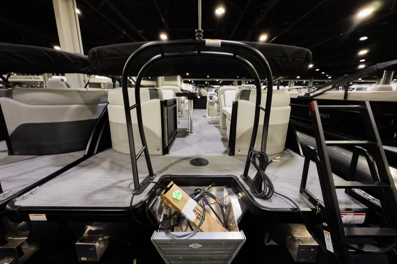 Slide: The Image of 2026 Godfrey Sweetwater 22' Split Bench Tritoon interior with seating and equipment. - 22