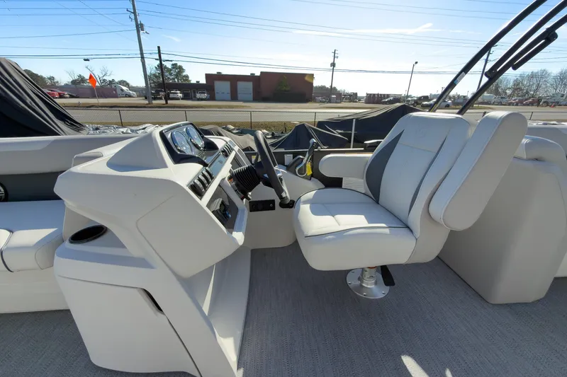 Slide: The Image of 2026 Godfrey Sweetwater 22' Tritoon interior with captain's chair and control panel. - 37