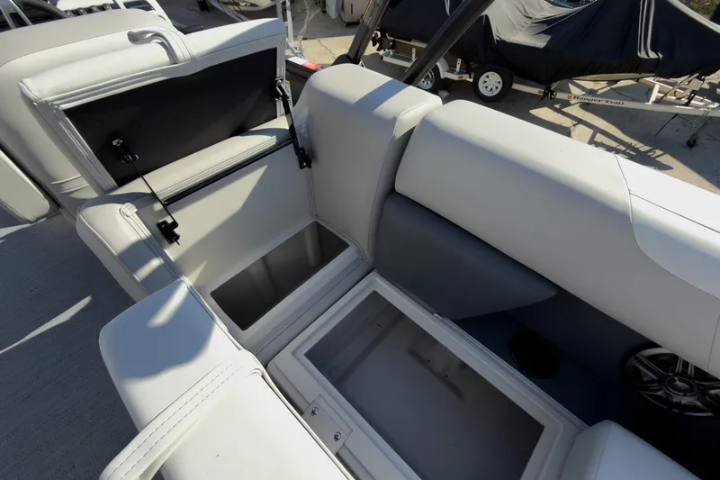 Slide: The Image of 2026 Godfrey Sweetwater 22' Tritoon storage compartments open, showcasing spacious seating and storage. - 49