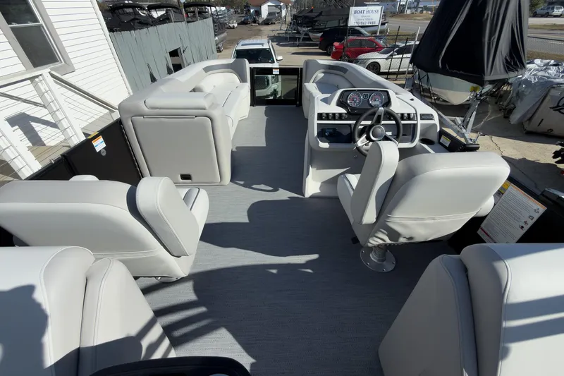 Slide: The Image of 2026 Godfrey Sweetwater 22' Split Bench Tritoon interior with modern seating and helm. - 55