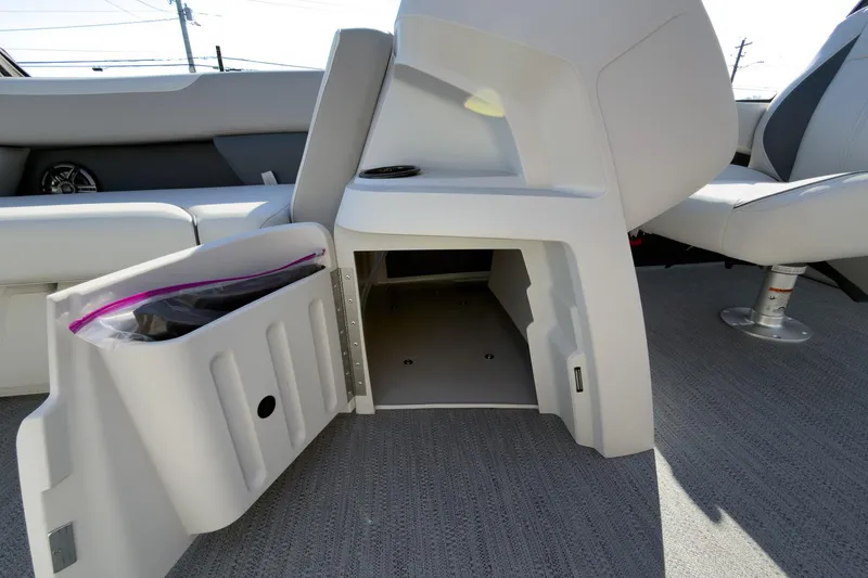 Slide: The Image of 2026 Godfrey Sweetwater 22' Tritoon storage compartment with open door, showcasing interior space. - 57