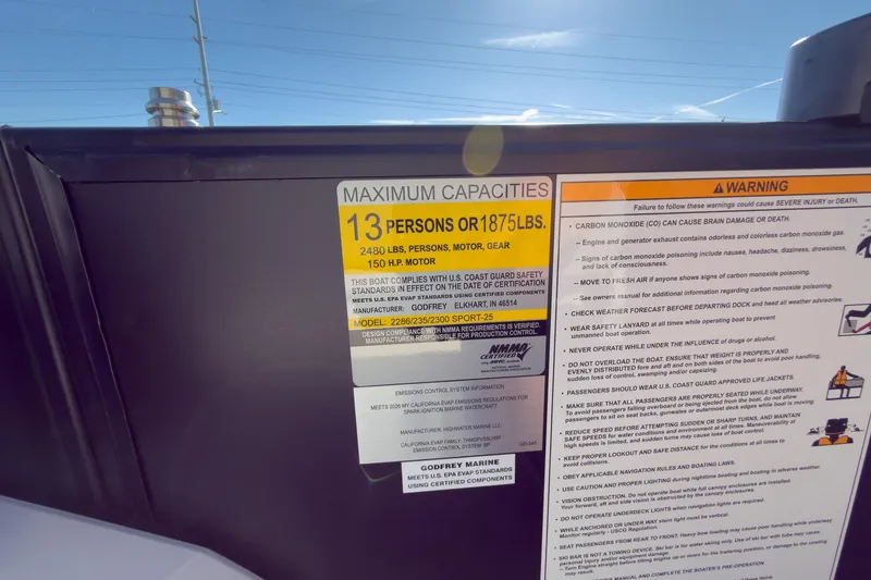 Slide: The Image of Maximum capacity label on 2026 Godfrey Sweetwater 22' Tritoon, 13 persons or 1875 lbs. - 58