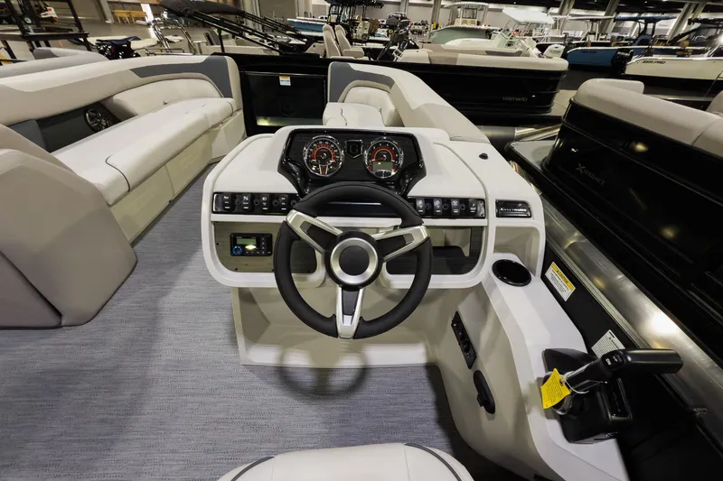 Slide: The Image of 2026 Godfrey Sweetwater 22' Tritoon helm with modern controls and plush seating. - 8