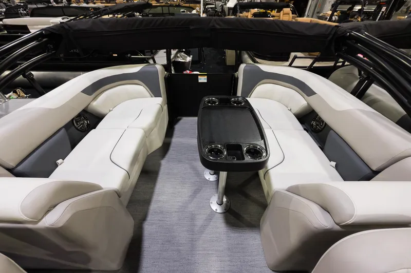 Slide: The Image of 2026 Godfrey Sweetwater 22' Split Bench Tritoon interior with plush seating and table. - 9