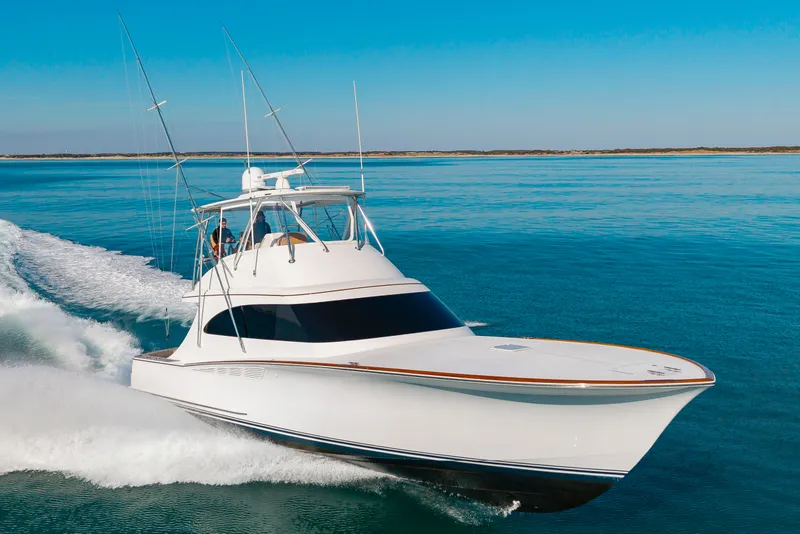 Slide: The Image of 2024 Albemarle Spencer Edition yacht cruising on calm waters. - 2