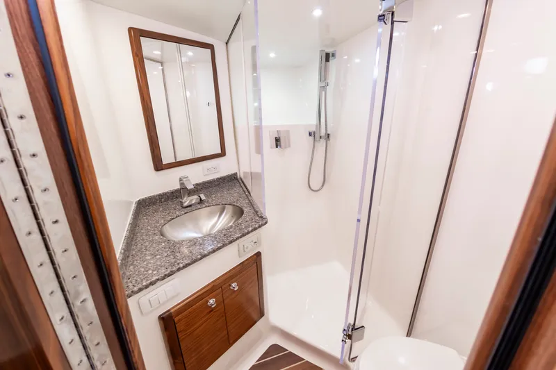 Slide: The Image of Luxurious bathroom in the 2024 Albemarle Spencer Edition boat. - 32